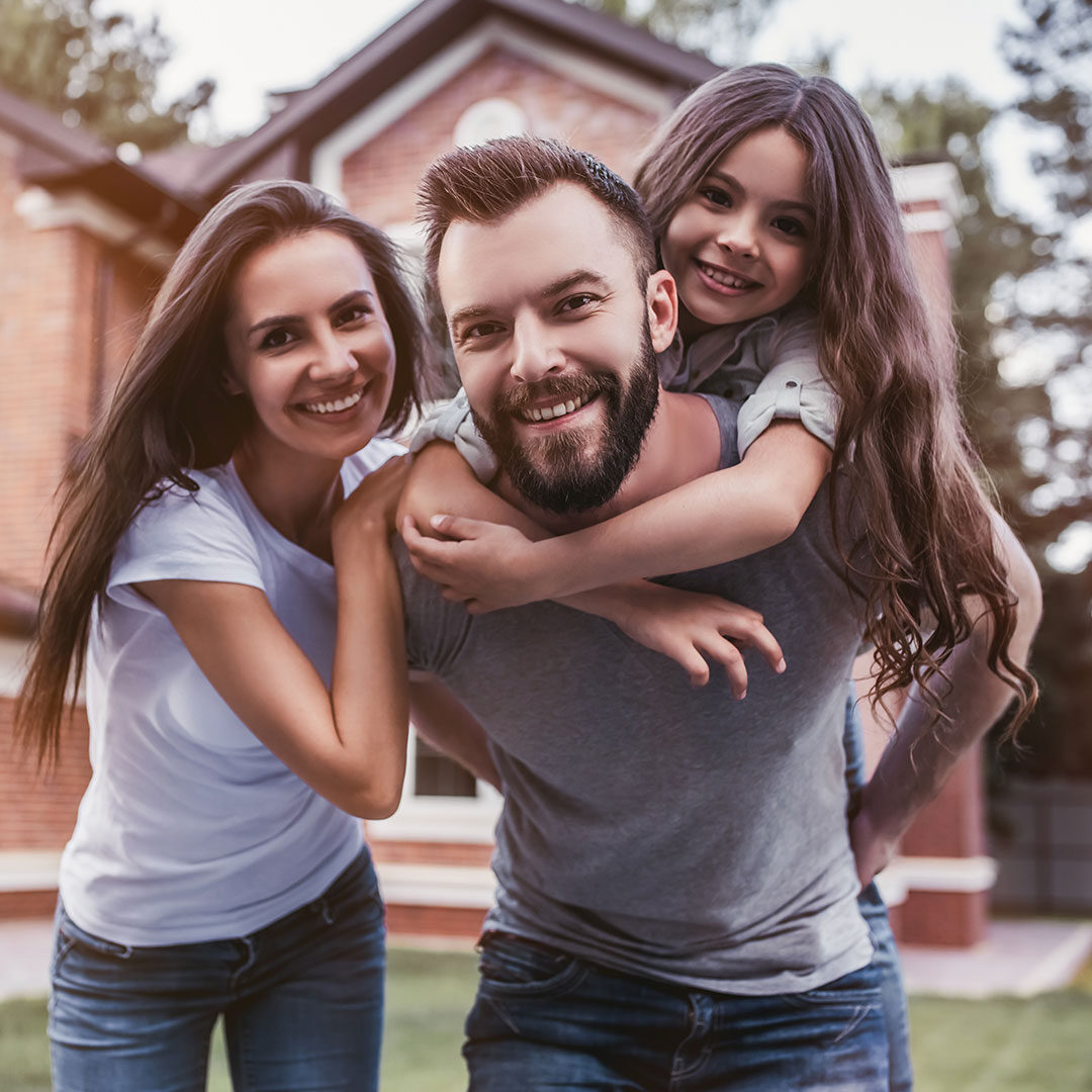 Happy Family in Front of Home